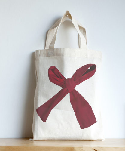 Image of mini tote featuring a red bow photographic print