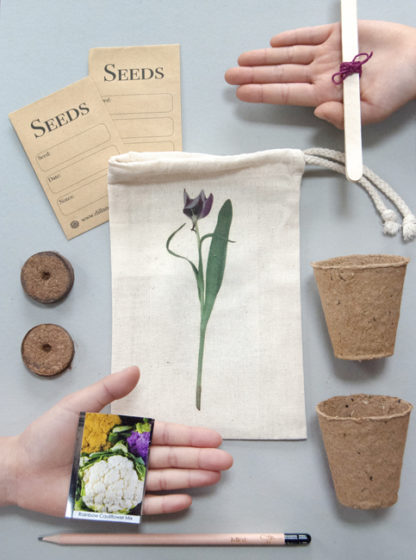 Display of gardening gift set including cotton drawstring bag featuring a photo design of a tulip