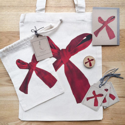 Red ribbon bow gift wrap set including eco-friendly note cards, gift tags, gift bags, wooden pin badge