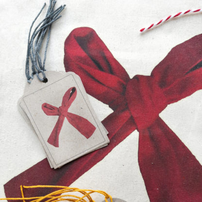 Set of gift tags featuring a red ribbon bow